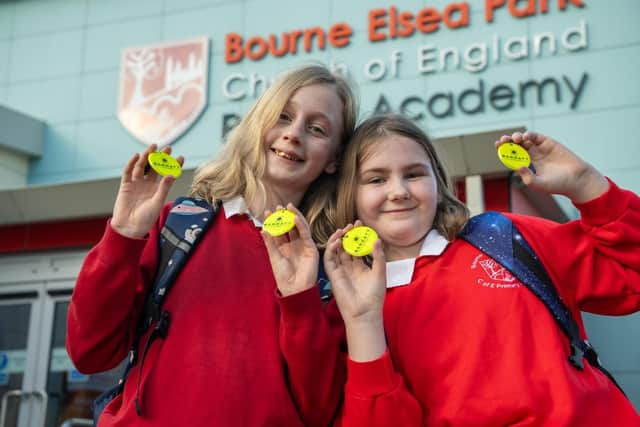 Pupils of Bourne Elsea Park C of E Primary School with the bag tags donated by Barratt and David Wilson Homes.