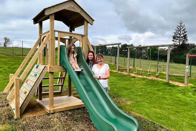 Ellie Dean, 4, with Piggywigs deputy manager Amy Westcough and manager Rae Knight at the nursery's outdoor play area.