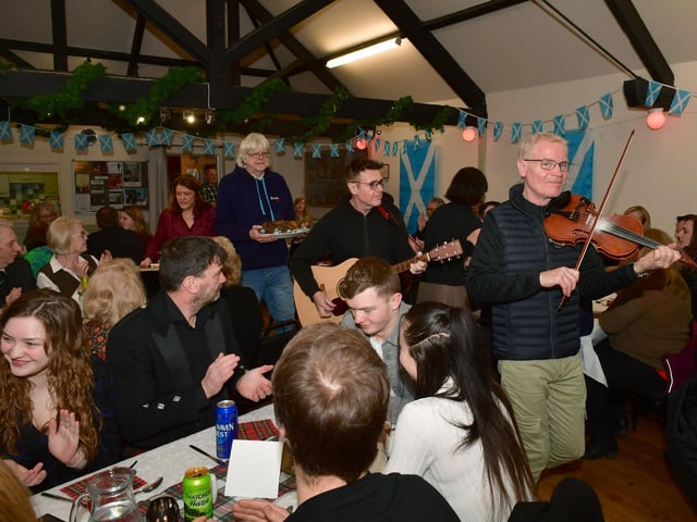 L-R Sean South, Tom Lane and Rick Alliwell, parading the haggis into the dining room at Ewerby Reading Room.