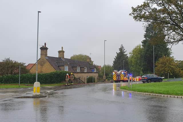 Firefighters working to pump out the flooded cottage at Holdingham.