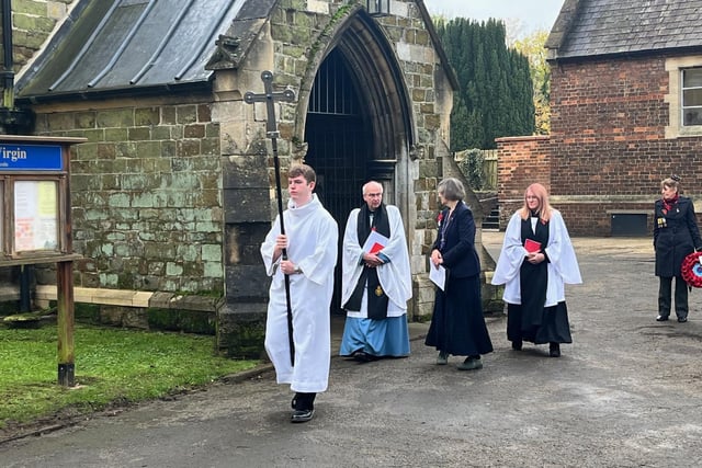 Rev Charles Patrick and Rev Lynne Hawkins lead the procession from the church.