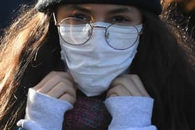 A woman wears a protective face mask as fears over coronavirus grow.. (Photo: Getty Images)