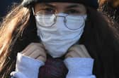 A woman wears a protective face mask as fears over coronavirus grow.. (Photo: Getty Images)
