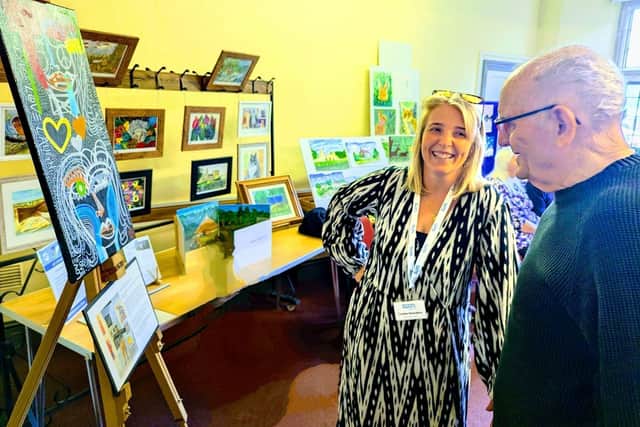 A resident at Chater Lodge and Louise from dementia south lincs at the community art exhibition