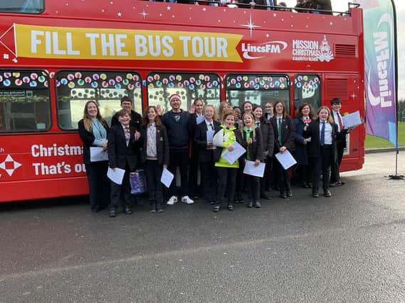 Stidents supporting the Lincs FM Mission Chrstmas appeal by filling a double decker bus with gifts for children in need.