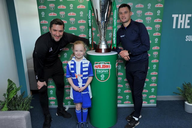 Pools fan Annabelle Pugh with Graeme Lee and Luke Molyneux next to the trophy.