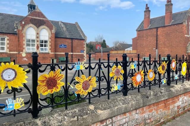 The children have created an art installation for the school railings, inspired by the Ukrainian flag and the the national flower, the sunflower.