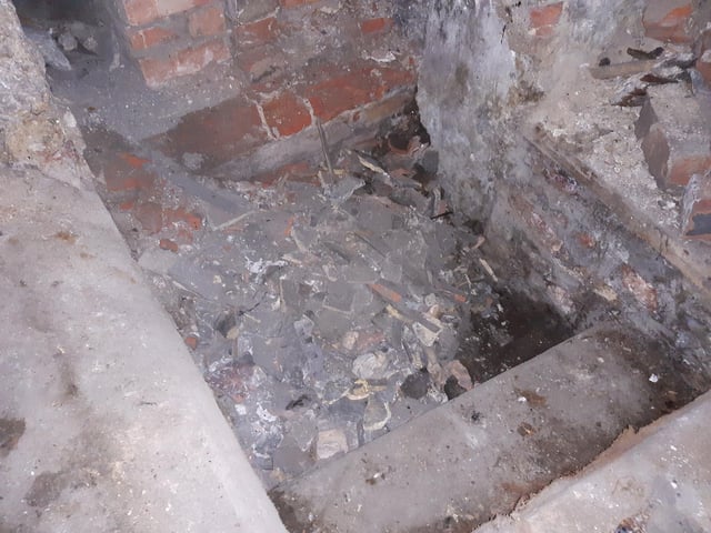 When Shane bought the former Cheers building, he thought he was getting a two-storey property. In fact, it turned out to have four floors. This photograph show steps leading down to the lowest-floor - a tunnel. The passageway is blocked with rubble (material from an old roof was put down a chimney and collected there). Shane plans to excavate this area, but describes it as a 'long, expensive process with lots of health and safety'. He suspects the tunnel connects with The Guildhall, but also the Haven, saying he notices he can smell salt at high tide. Finds in the area include: an antique bottle, the tops of old lamps, and a complete goat skeleton.