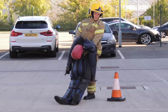 Firefighter Laurel Ray demonstrates the casualty rescue challenge, dragging a 55lb dummy along a course against the clock.