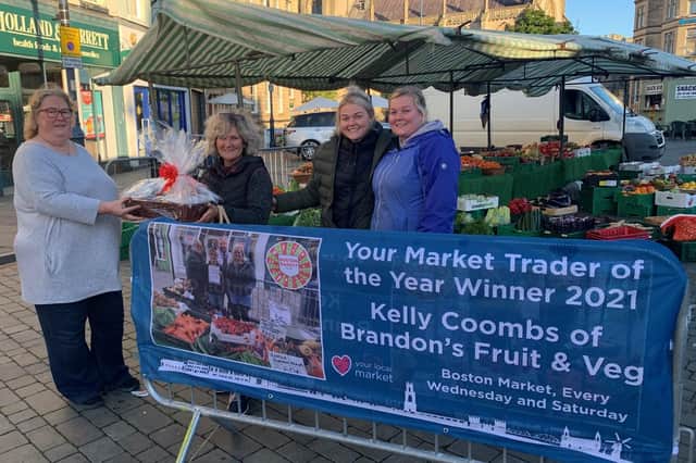 Coun Tracey Abbott (Portfolio Holder), presents Kelly and her daughters with her winning prizes in 2021 Trader of the Year for Brandon Fruits.