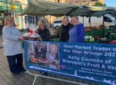Coun Tracey Abbott (Portfolio Holder), presents Kelly and her daughters with her winning prizes in 2021 Trader of the Year for Brandon Fruits.