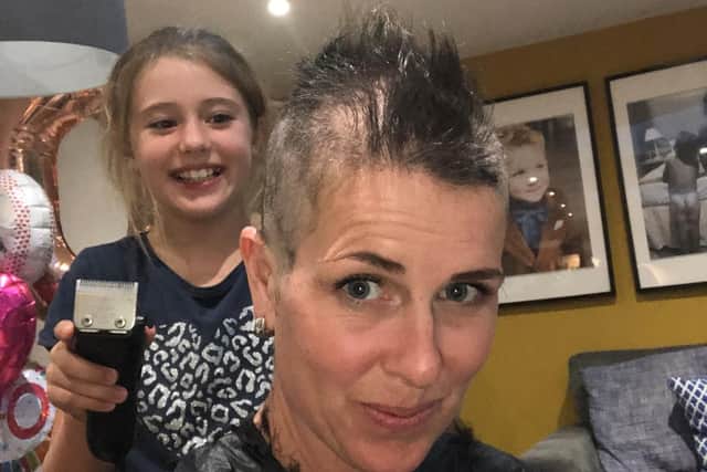 Dorrie shaves her mum Michelle's head.