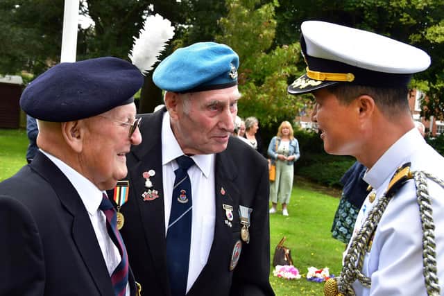 Capt. Hyung Lee of the Defence Attache of the Republic of Korea (right) chats to Korean Veterans John Ingle and John Waters.