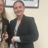 Marith Leafe, High School Head Girl and Lois Copeland, Year 12 History Prefect, holding the old school bell. Photo supplied