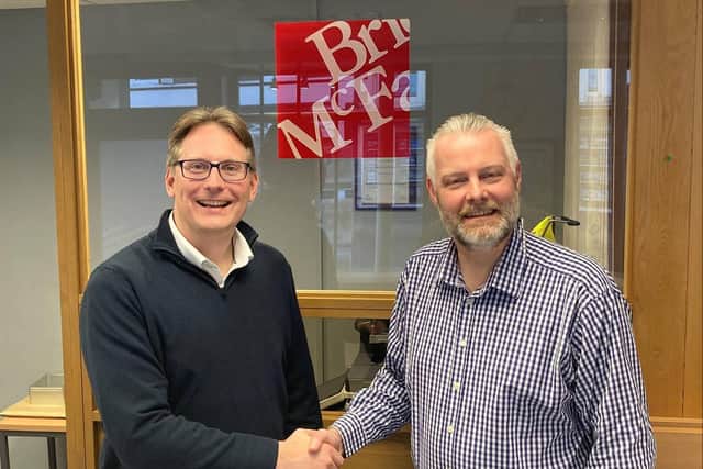 Dale Crombleholme (right) being congratulated on his achievement by Managing Partner Stephen Oldridge