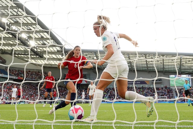 Lauren Hemp scores England's second goal under pressure from Maren Mjelde.