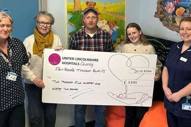 Owen Gillman (centre), Judith Laird, (left) Alice Short (right) presenting a cheque to members of Ward 41 Children’s Ward, at Boston's Pilgrim Hospital.