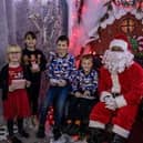 Santa Clause  greets children at the Phoenix Fitness Grotto.