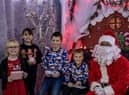 Santa Clause  greets children at the Phoenix Fitness Grotto.