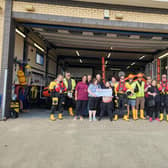 Alderson House ​residents presenting the cheque to the RNLI in Mablethorpe.