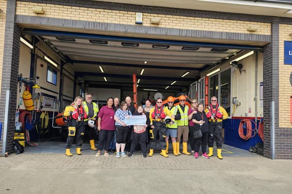 Alderson House ​residents presenting the cheque to the RNLI in Mablethorpe.