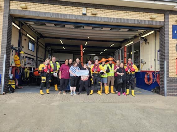 Alderson House residents presenting the cheque to the RNLI in Mablethorpe.
