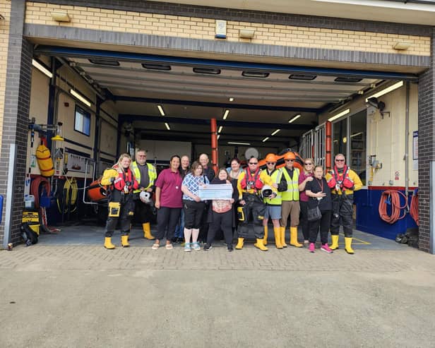 Alderson House ​residents presenting the cheque to the RNLI in Mablethorpe.