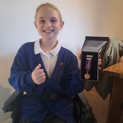 Little Trooper - aspiring young actress Isobel Johnson receives a medal from a military children’s charity.