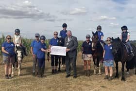 Coun Selby hands over a cheque to Kesteven Rideabiity.