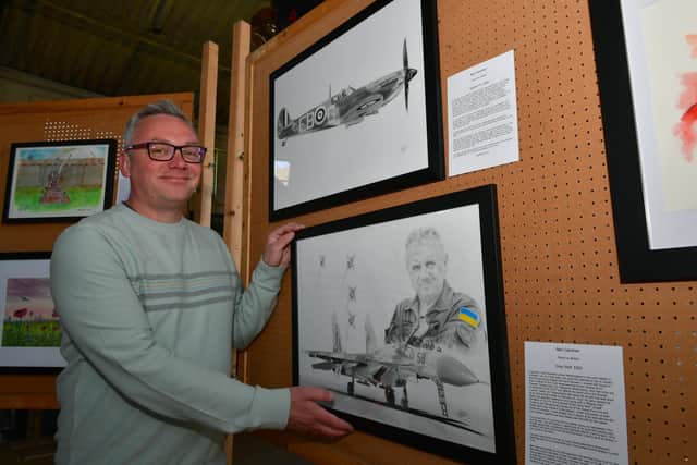 One of the artists, Neil Gardner of Melton with his art work at the exhibition at Metheringham airfield.