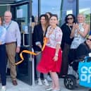 MP for Louth and Horncastle Victoria Atkins (sixth from left) and resident  Luke Smith-Ridehalgh, whose inspiring story captured the hearts of many on the day, cutting the ribbob.
