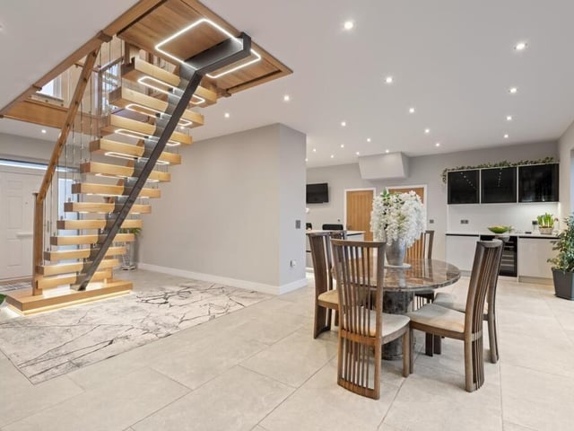 The dining section of the open-plan kitchen, dining room, lounge, looking towards the kitchen.