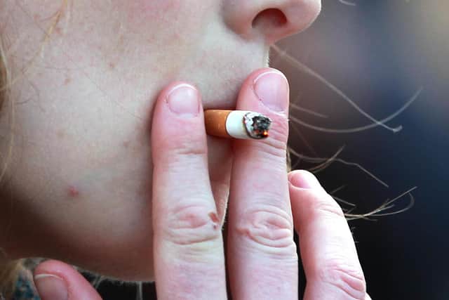 A woman smoking in central London.
