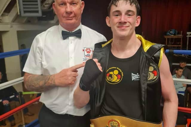 Reece Morris pictured with East Midlands official and belts organiser Ady Corssen