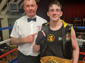 Reece Morris pictured with East Midlands official and belts organiser Ady Corssen