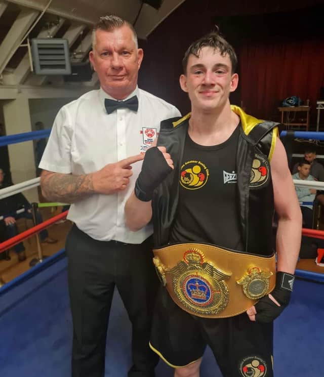 Reece Morris pictured with East Midlands official and belts organiser Ady Corssen