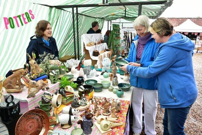 Busy Bee H Allam of London at the Rackapelt Potters stall with (from left) Jane Babb of Alvingham and Jude Hall of Tetford.