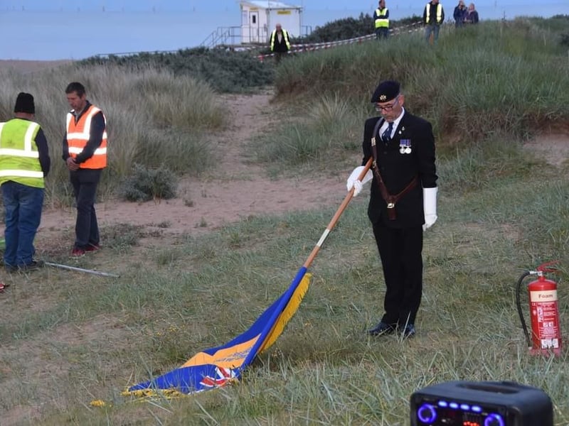 The Skegness branch of the Royal British Legion Standard is lowered.