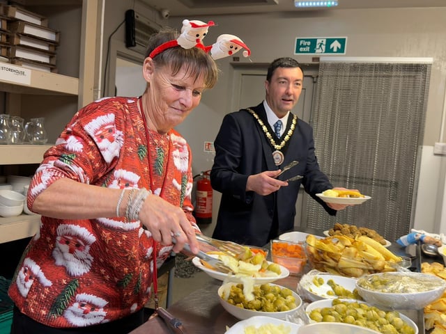Coun Susan Royal and Mayor Coun Jimmy Brookes dishing up meals.