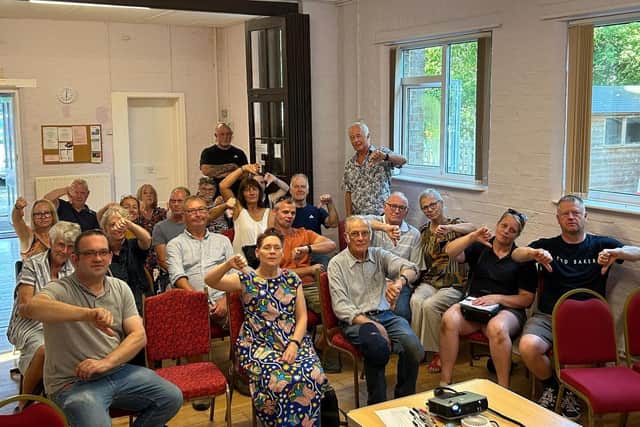 Residents at a meeting in Keal Cotes give the 'thumbs down' to plans for a new chicken farm in the village.