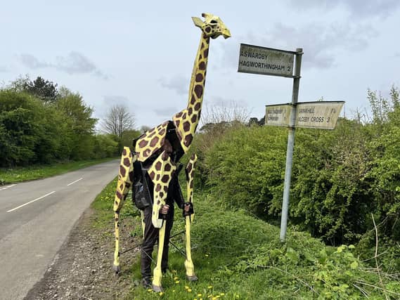 Sebastian Mayer with life-size giraffe puppet Zarafa in Harrington.