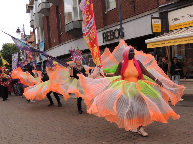 The procession continues with more vivid displays of colour.