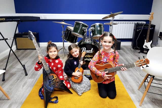 Children learning to play guitar during Learn to Play '22