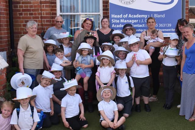Kate, pictured centre with the black hat, with staff and pupils during their 'Mad Hatters' celebration.