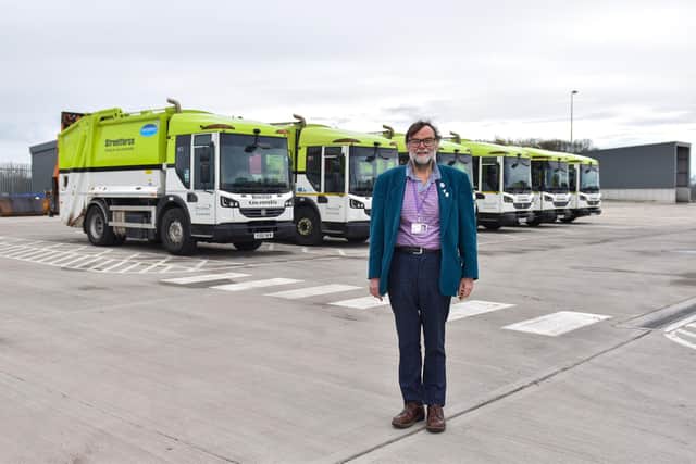 Coun Stephen Bunney, Chair of the council’s Environment, Sustainability and Climate Change working group with the lorries. Image: WLDC