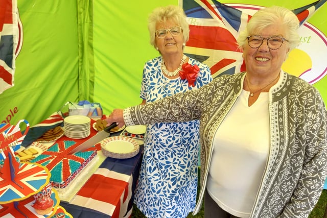 The Butterfly Hospice's long-term supporters, sisters Thelma Fountain and Pam Bell, cut the union flag-themed cake produced by the hospice chefs.