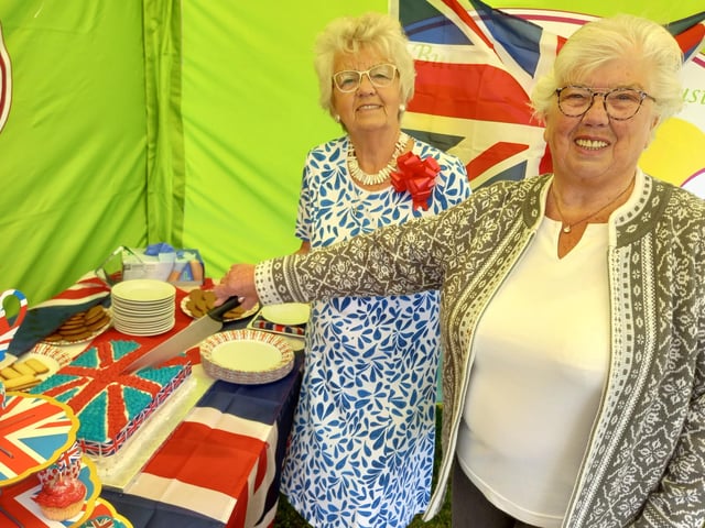 The Butterfly Hospice's long-term supporters, sisters Thelma Fountain and Pam Bell, cut the union flag-themed cake produced by the hospice chefs.