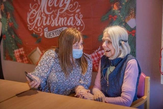 Margaret Knudsen, a resident living with dementia listening to a MediMusic playlist last year at Orchard Court Care Home in Brigg, North Lincolnshire.