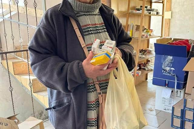 A Ukrainian lady collecting aid from one of the boxes