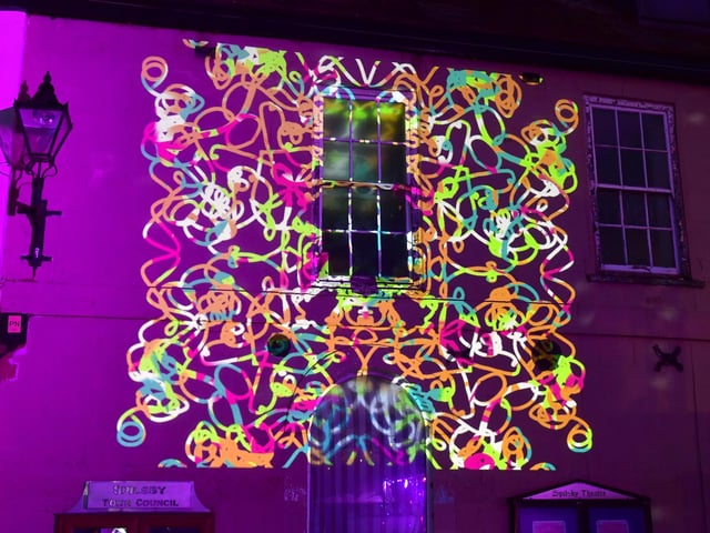 A light show on the wall of a building in Spilsby.